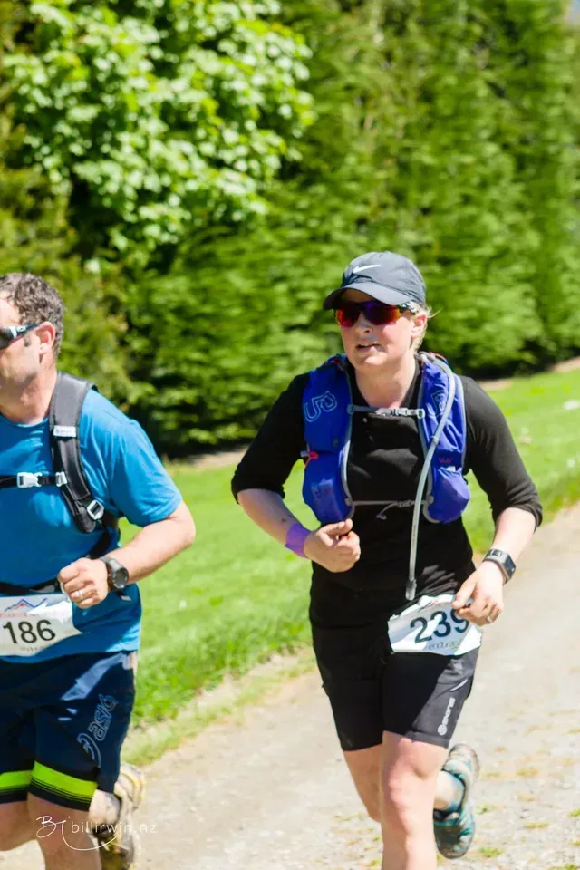 A man and a woman are running in a race.