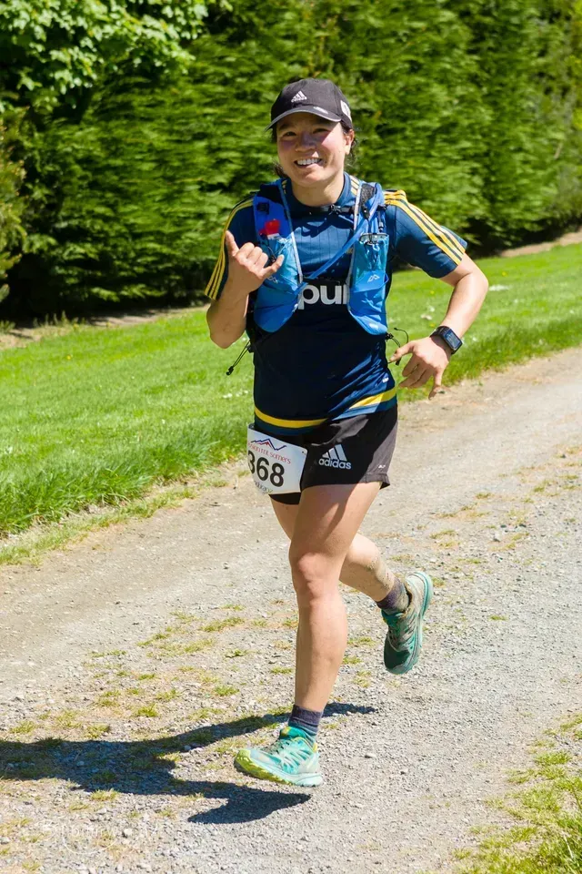 A woman is running on a dirt road.