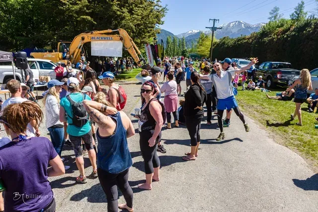 A group of people are standing on the side of a road.