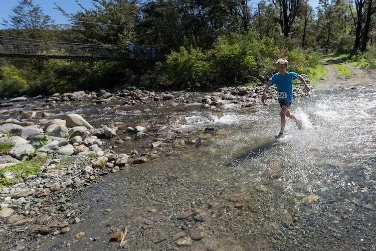 A person is running through a stream of water.