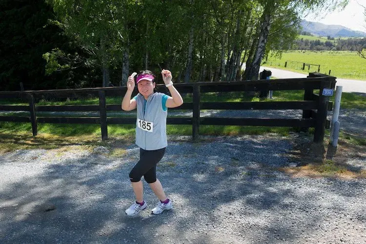 A woman wearing a gray vest with the number 929 on it