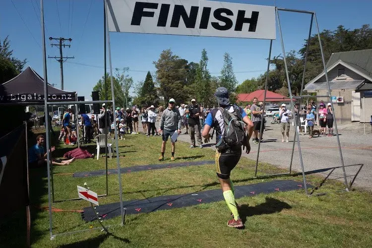 A man is crossing the finish line of a race.