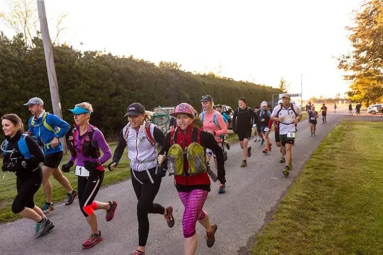 A group of people are running down a path.