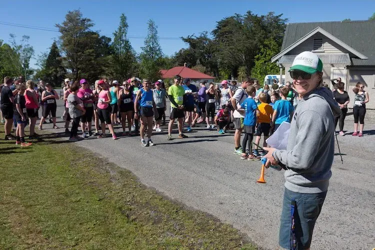 A man is standing in front of a large group of people.