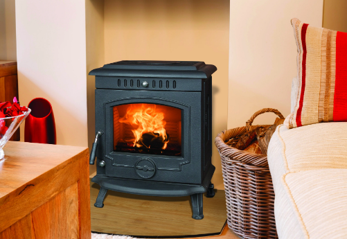 A living room with a wood stove and a basket of logs