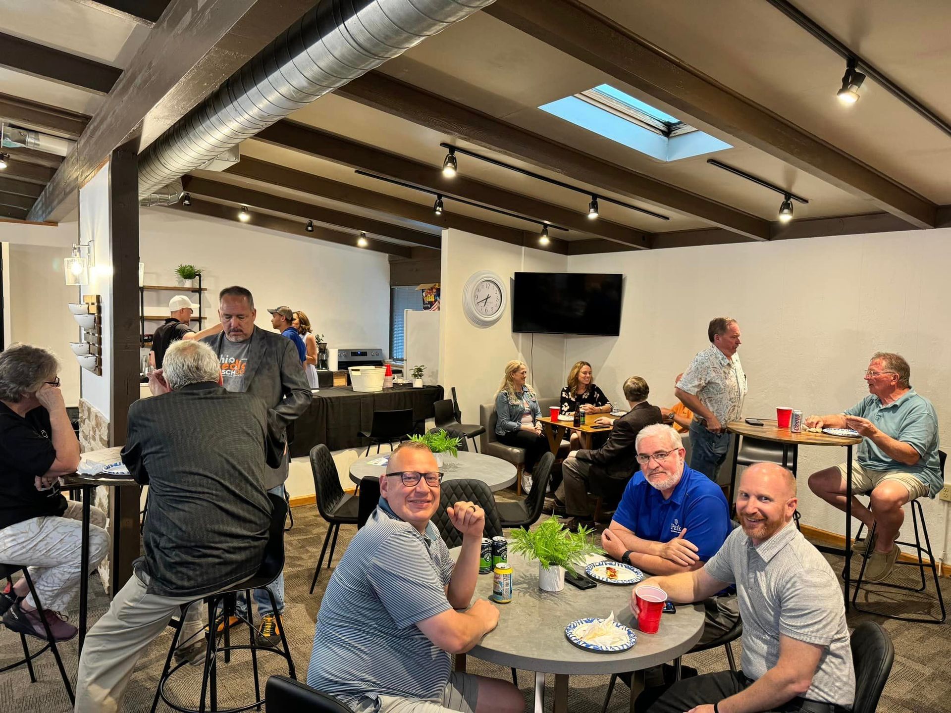 A group of people are sitting at tables in a room.