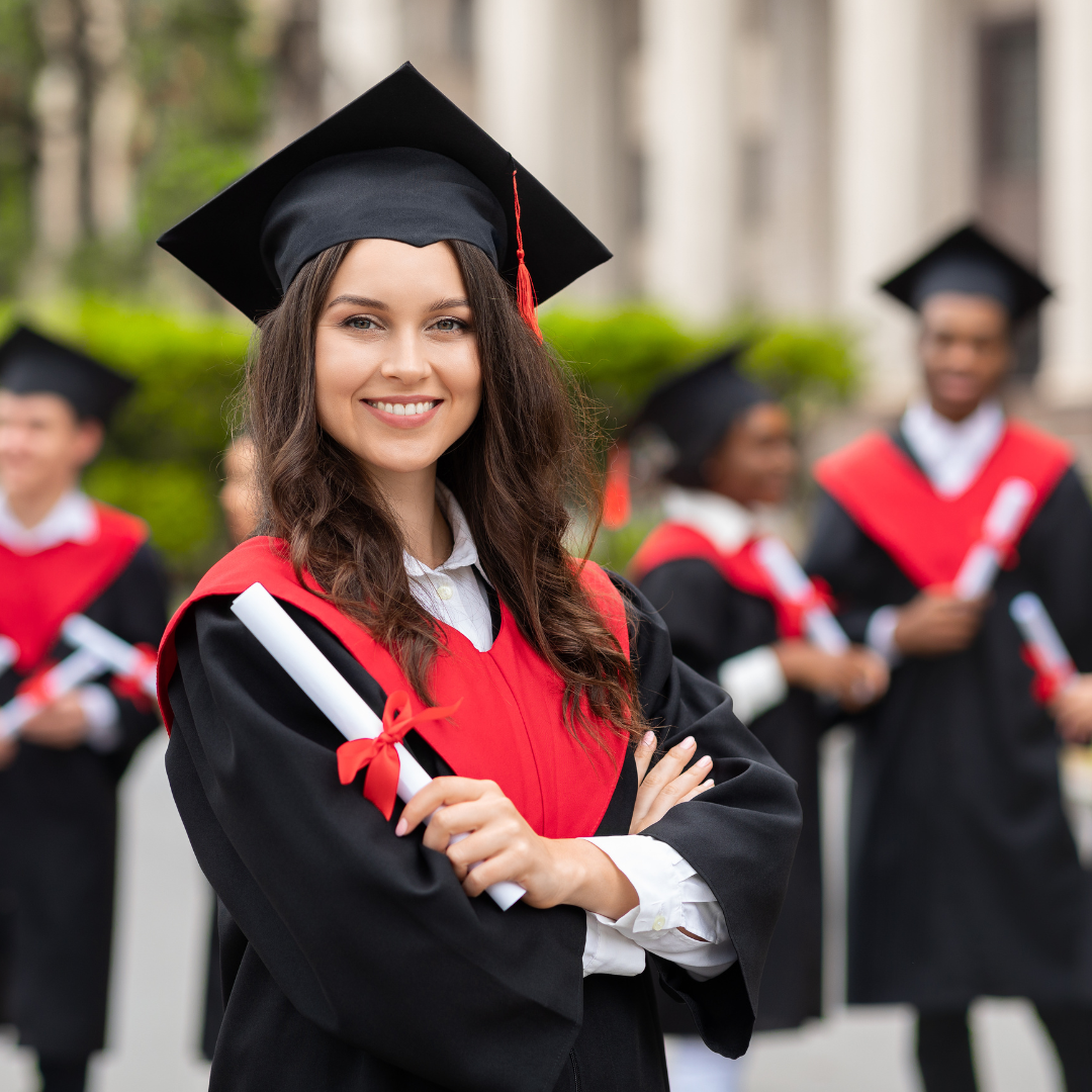 A woman in a graduation cap and gown is holding a diploma.