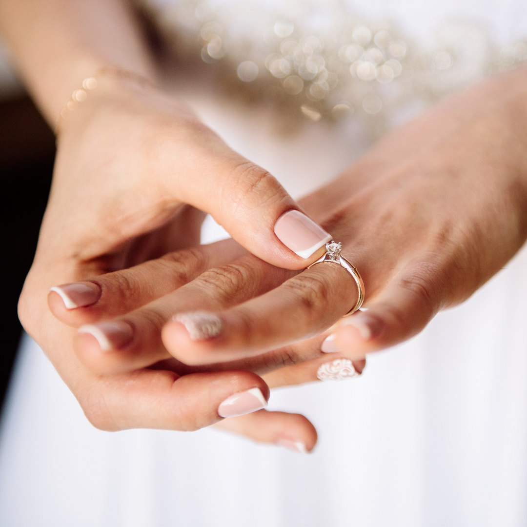 A woman wearing a wedding ring on her finger