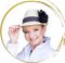 A woman wearing a hat with a black flower on it