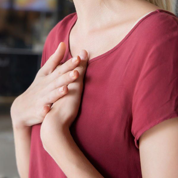 Woman with chest pain from GERD Gastroesophageal Reflux Disease