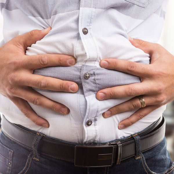 Man Bloating from Lactose Intolerance
