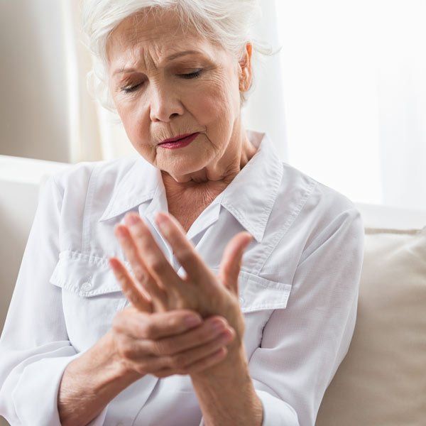 Woman with Symptom of Joint Pain wondering What is Rheumatoid Arthritis?