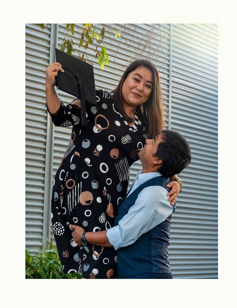 Woman Holding Graduation Cap Carrying by Man — Up Here Photography in Rosebery, NT
