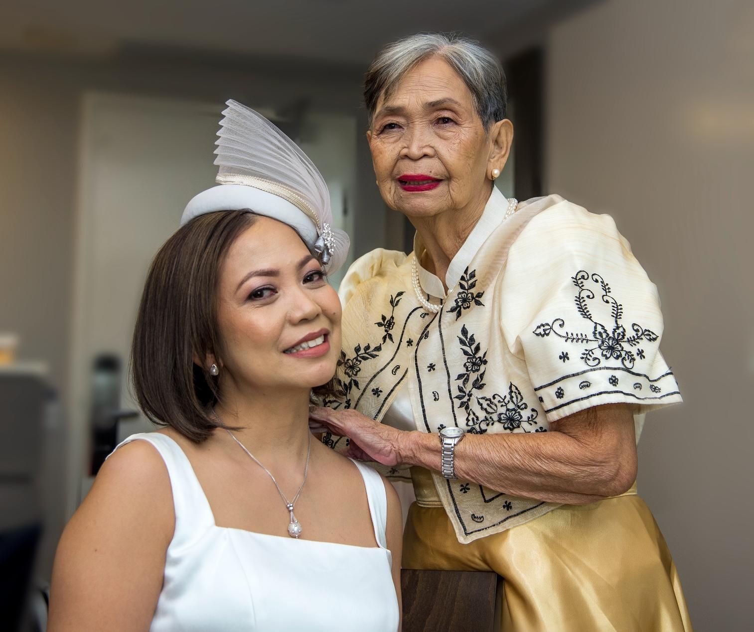 A Bride Wearing White Hat and Her Mother — Photography in Darwin, NT