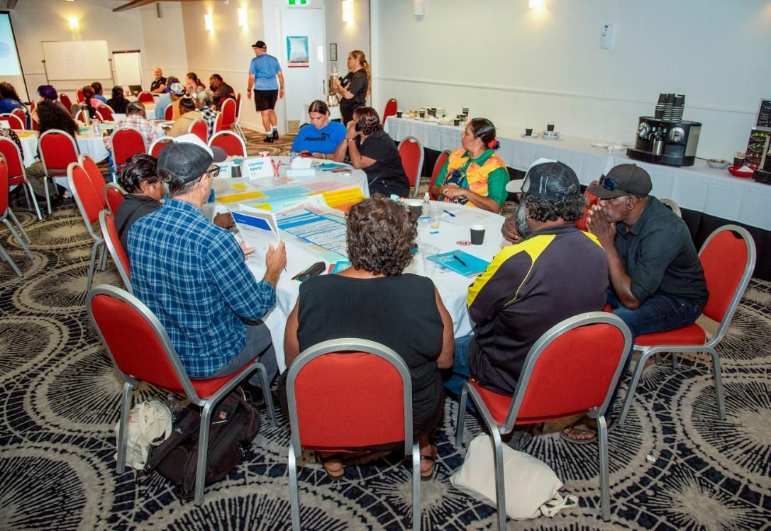 People Seated Around a Circular Table in a Large Room — Up Here Photography in Howard Springs, NT