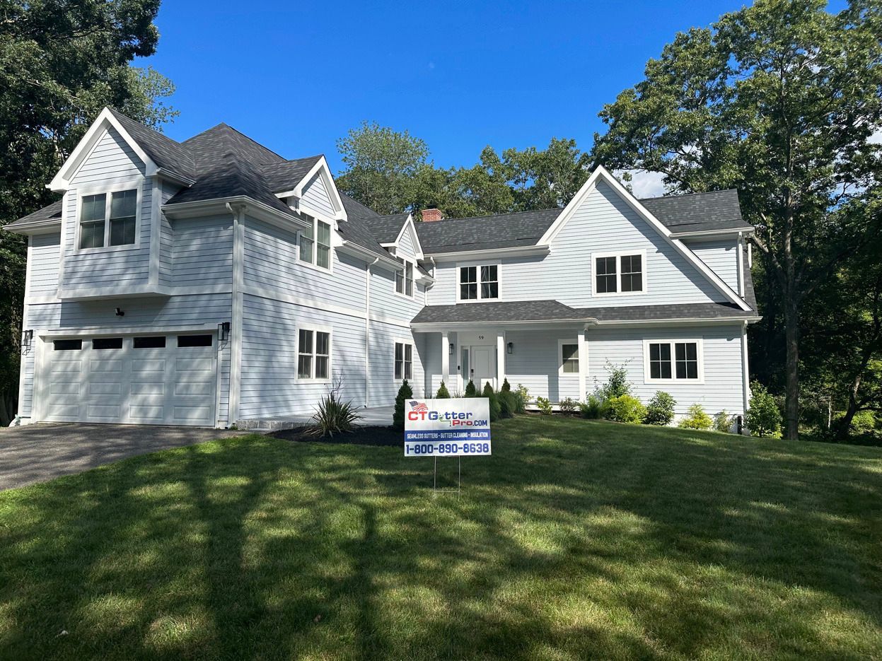 CT GutterPro yard sign in front of stunning new-construction home