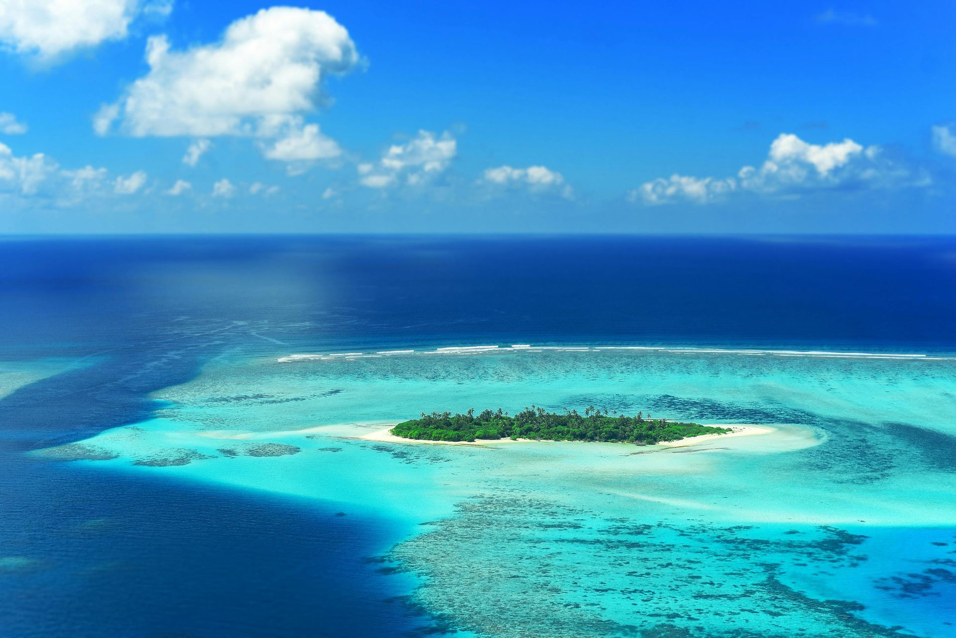 An aerial view of a small island in the middle of the ocean.