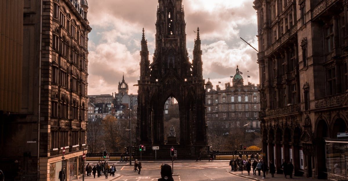 A group of people are walking down a city street in front of a large building.