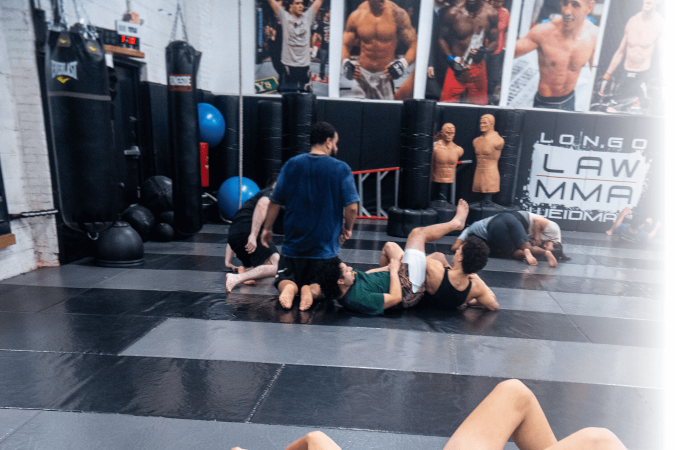 Adults training pads and grappling basics at Ray Longo's Mixed Martial Arts in Garden City, NY.