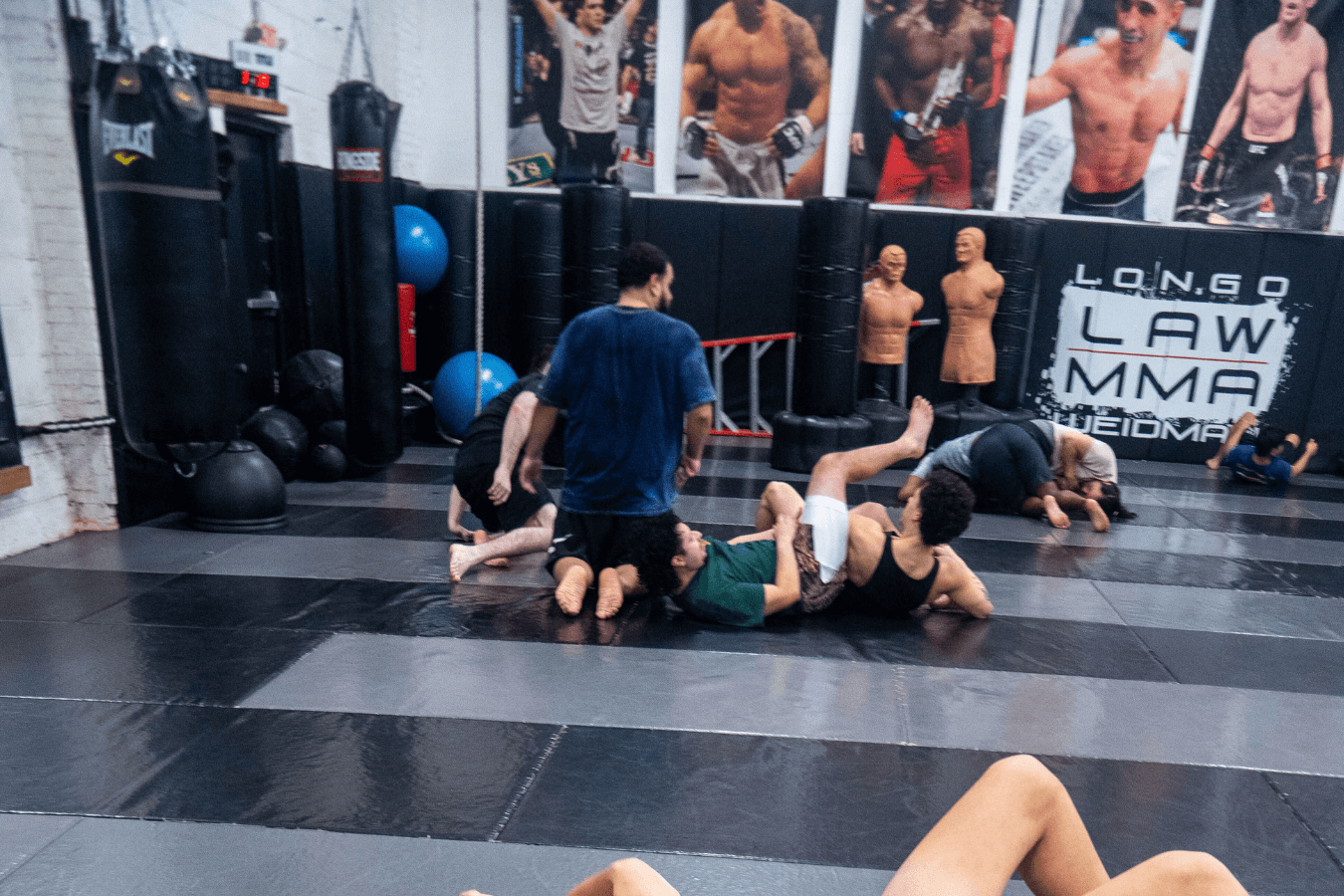 Adults training pads and grappling basics at Ray Longo's Mixed Martial Arts in Garden City, NY, building fitness and confidence