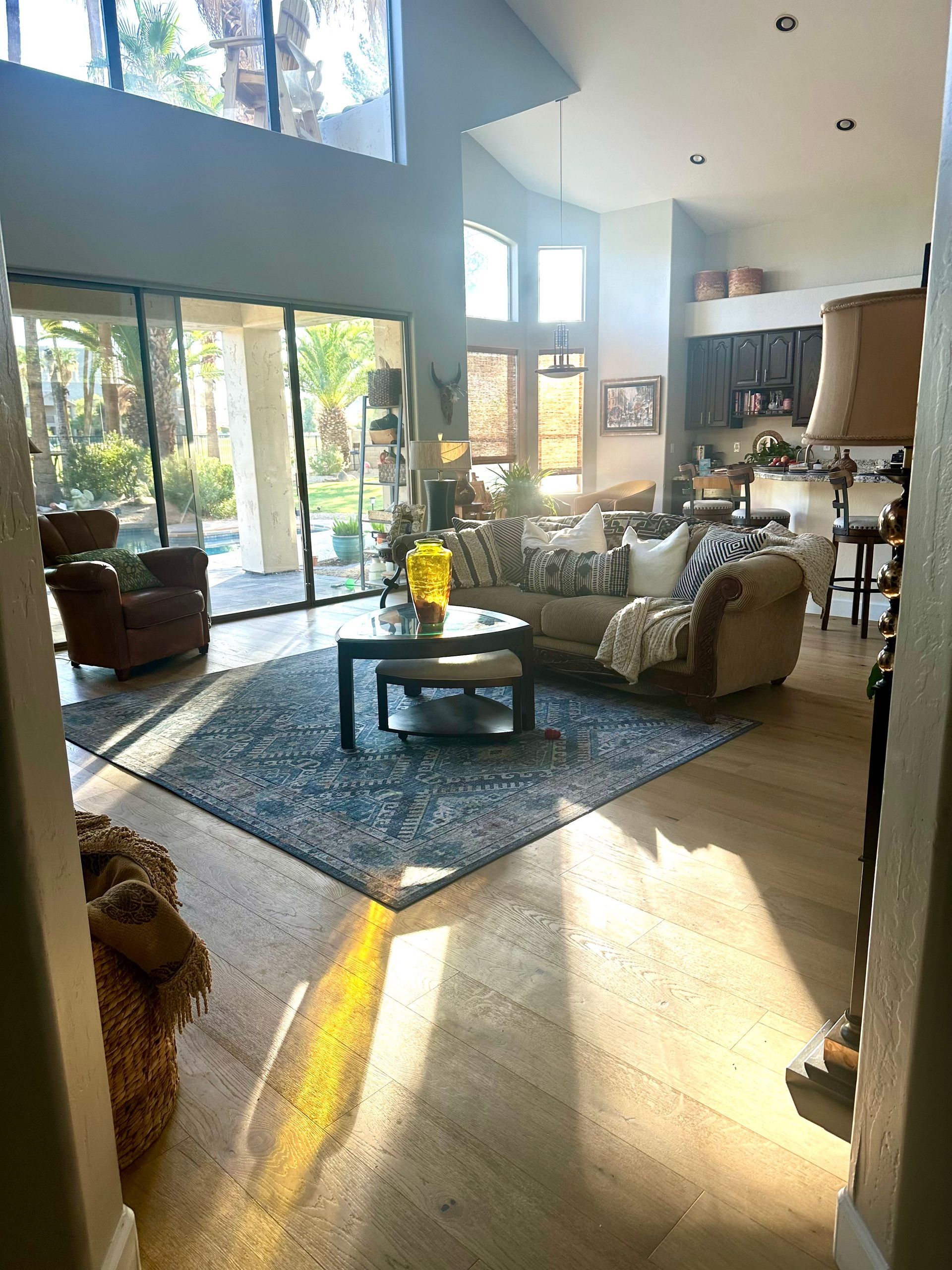 A living room with a couch , chair , coffee table and rug.