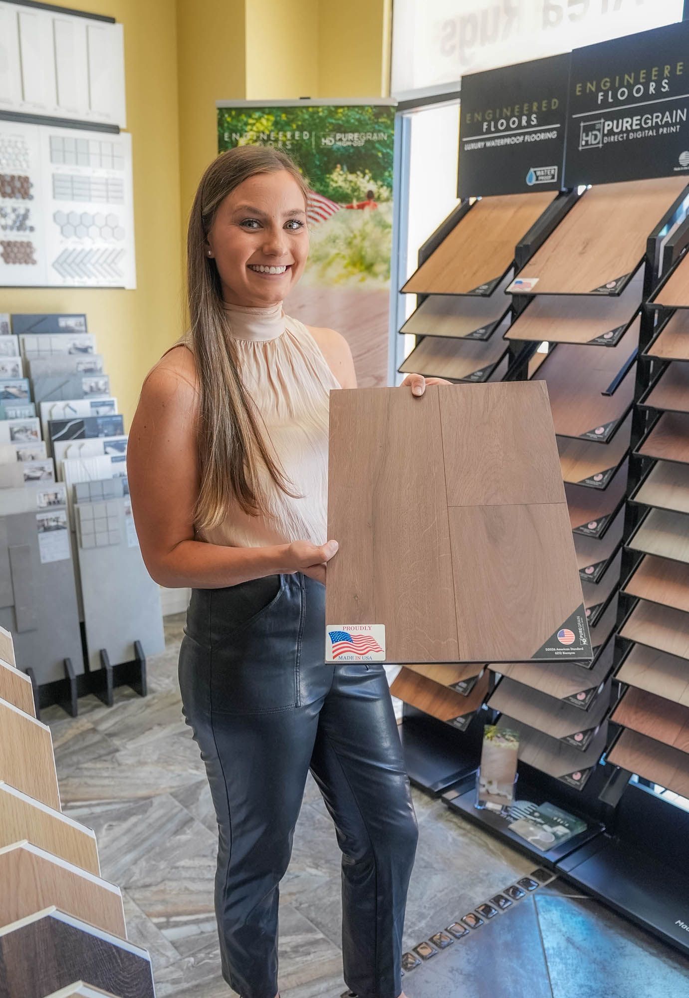 A woman is holding a piece of wood in a store.