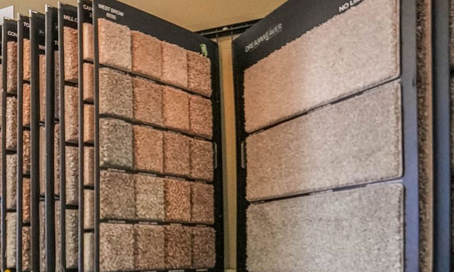 A display case filled with a variety of carpet samples.