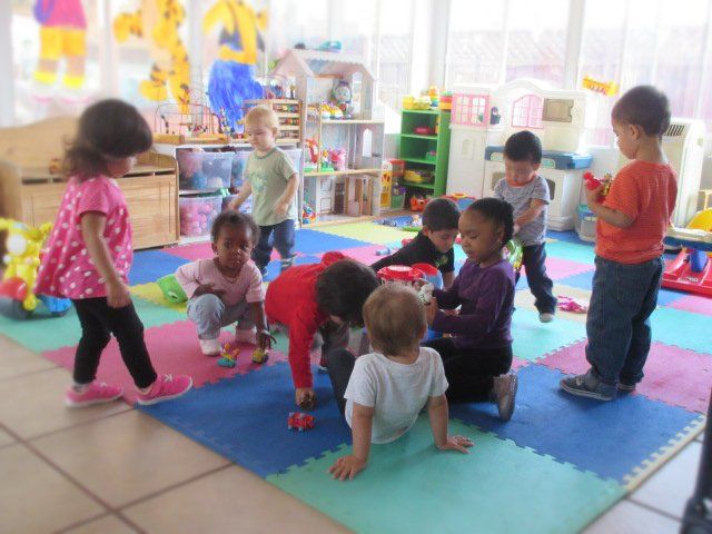 children playing on a mat at Anna's Day Care