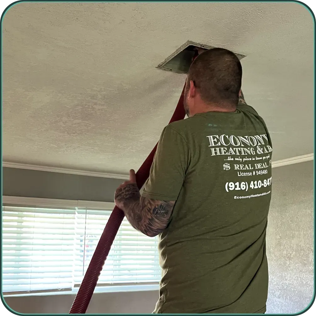 A man wearing a green shirt that says econon heating and cooling