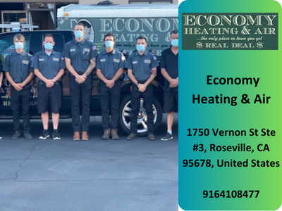 A group of men wearing masks are standing in front of a economy heating and air truck.