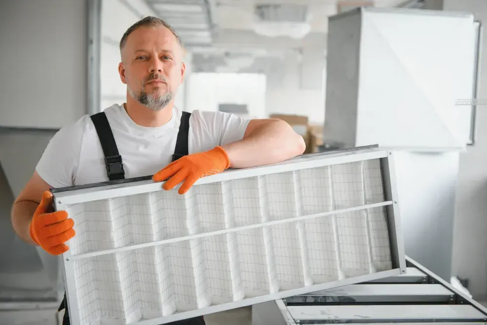 A man is holding a filter in his hands.