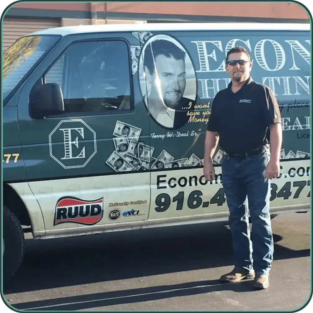 A man standing in front of a van that says econo heating