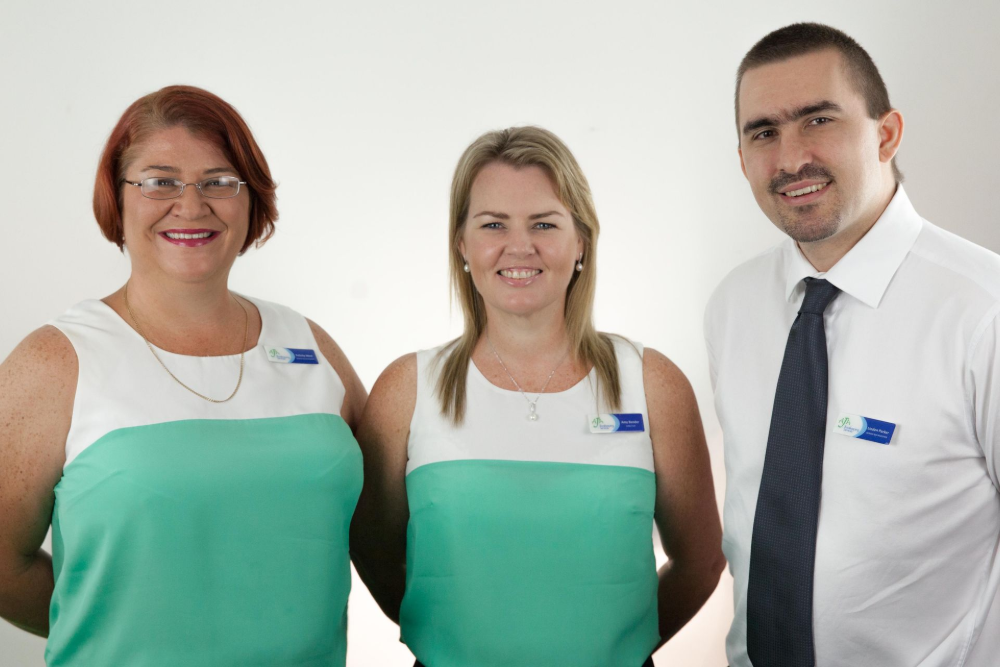 4 People Are Posing For A Photo — AJA Bookkeeping Services In Cairns, QLD