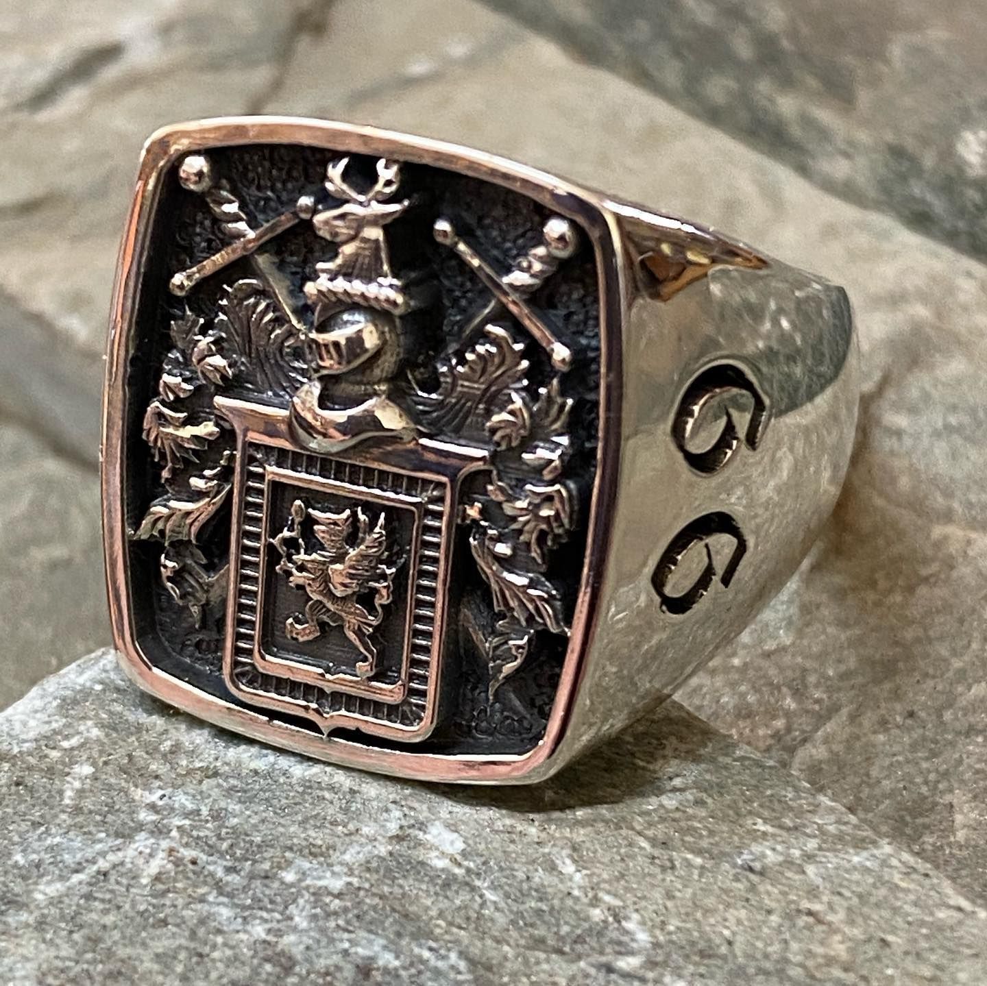 A silver ring featuring an ornate heraldic coat of arms with a stag crest — Burchell's Jewellers In Bowral, NSW