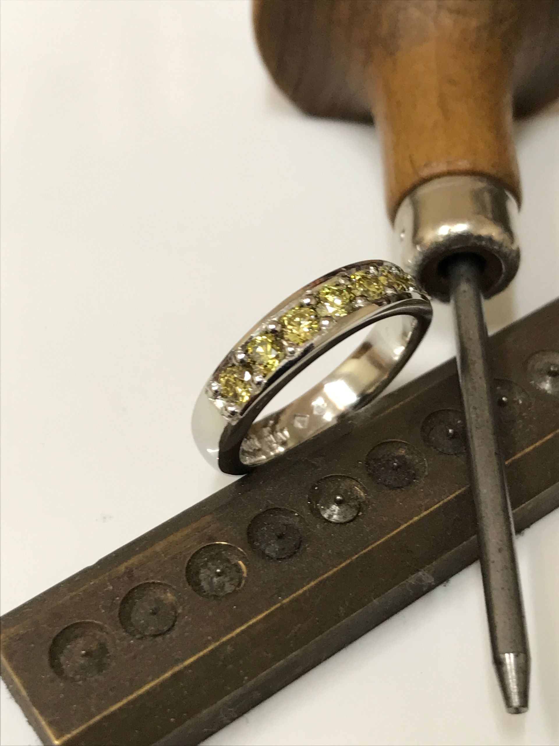 Silver Ring With Yellow Gemstones Near Jewelry Tools — Burchell's Jewellers In Bowral, NSW