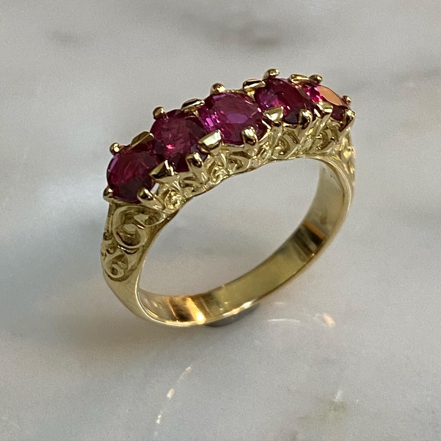 Gold Ring With Five Oval-cut Red Gemstones Set in an Ornate, Swirling Design — Burchell's Jewellers In Canberra, NSW