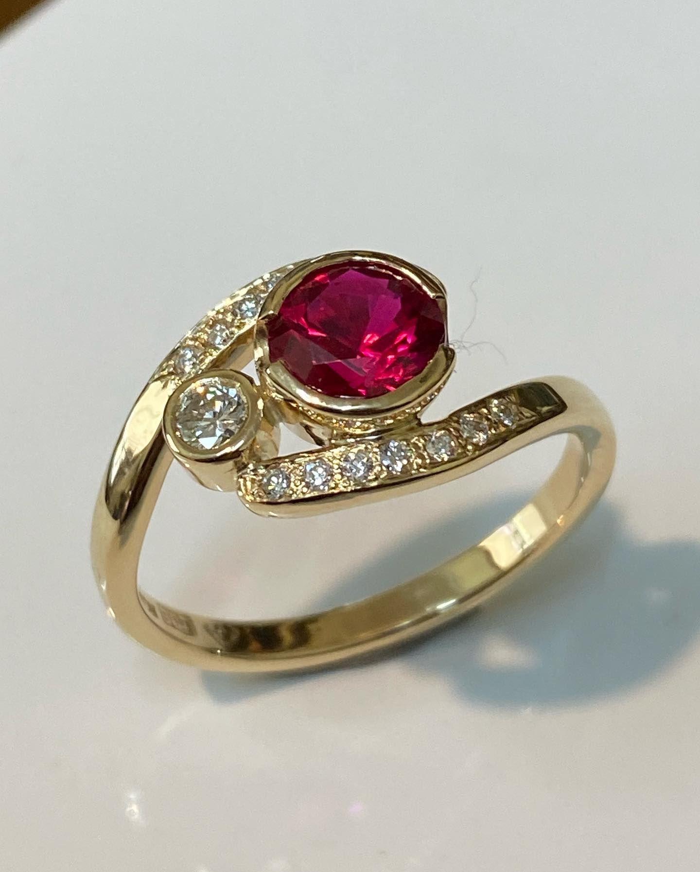 Gold Ring With a Red Oval Gemstone and Small White Diamonds — Burchell's Jewellers In Bowral, NSW