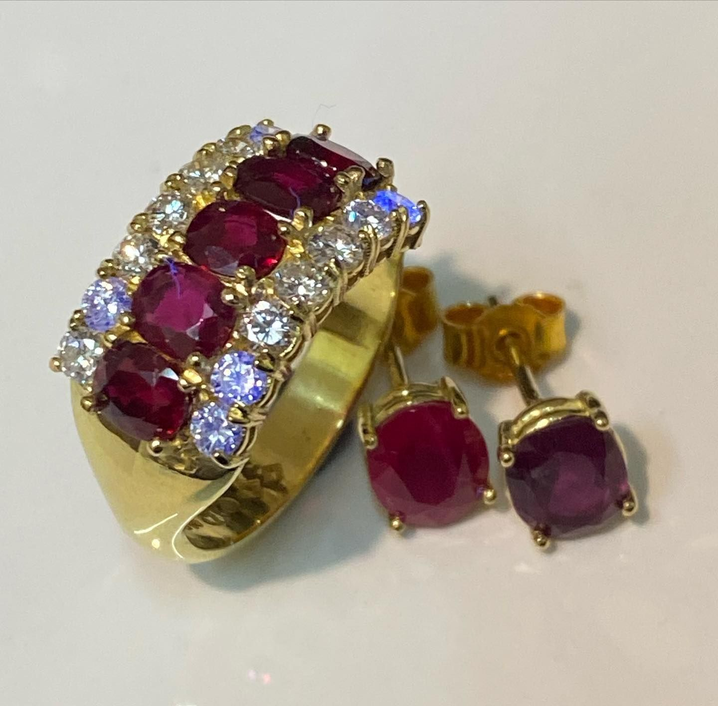 Gold Rings and Earrings With Green Stones, Displayed on a White Surface — Burchell's Jewellers In Bowral, NSW