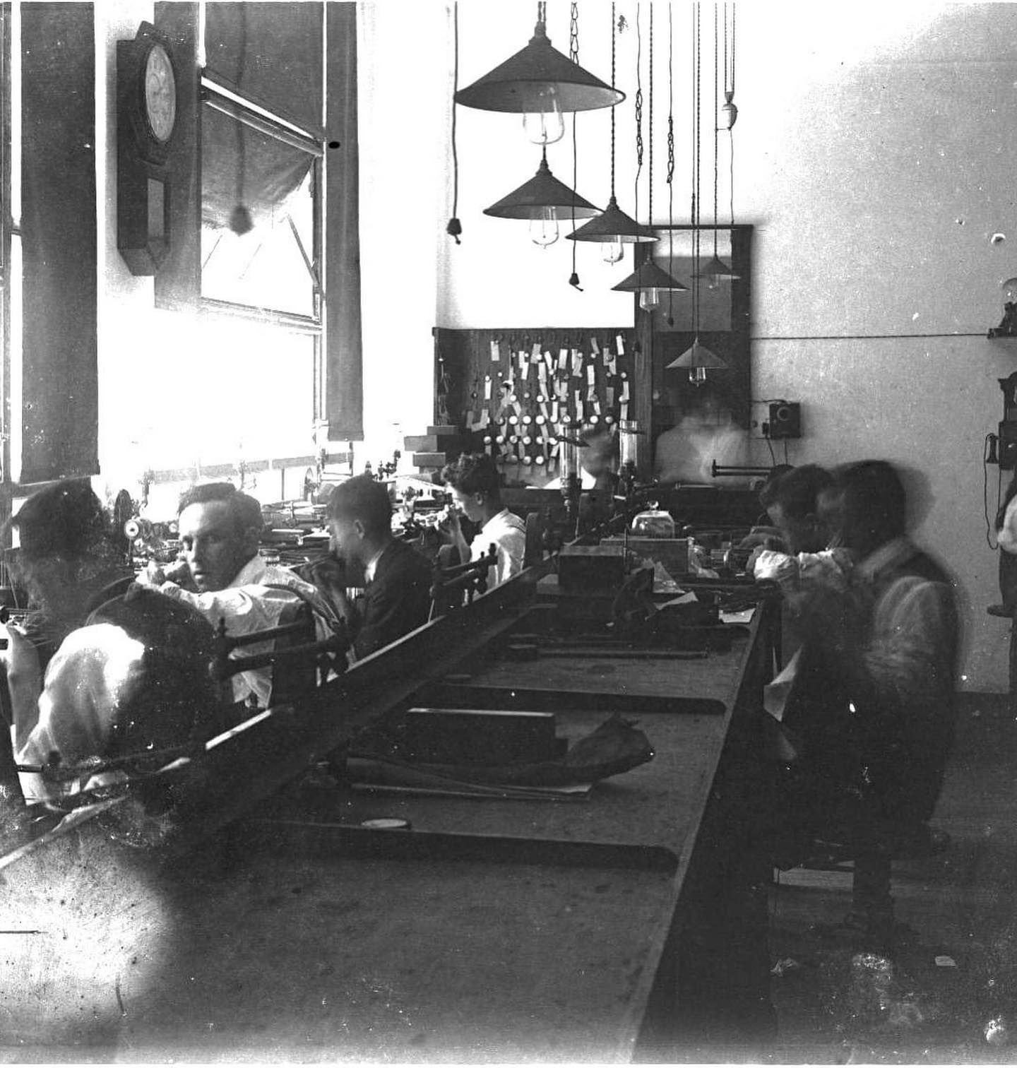 A Workshop With People Seated at Long Tables, Working — Burchell's Jewellers In Bowral, NSW