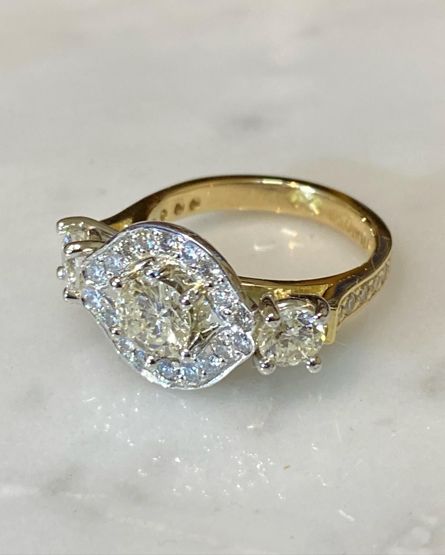 Gold engagement ring with three diamonds, center stone surrounded by smaller stones. — Burchell's Jewellers In Bowral, NSW