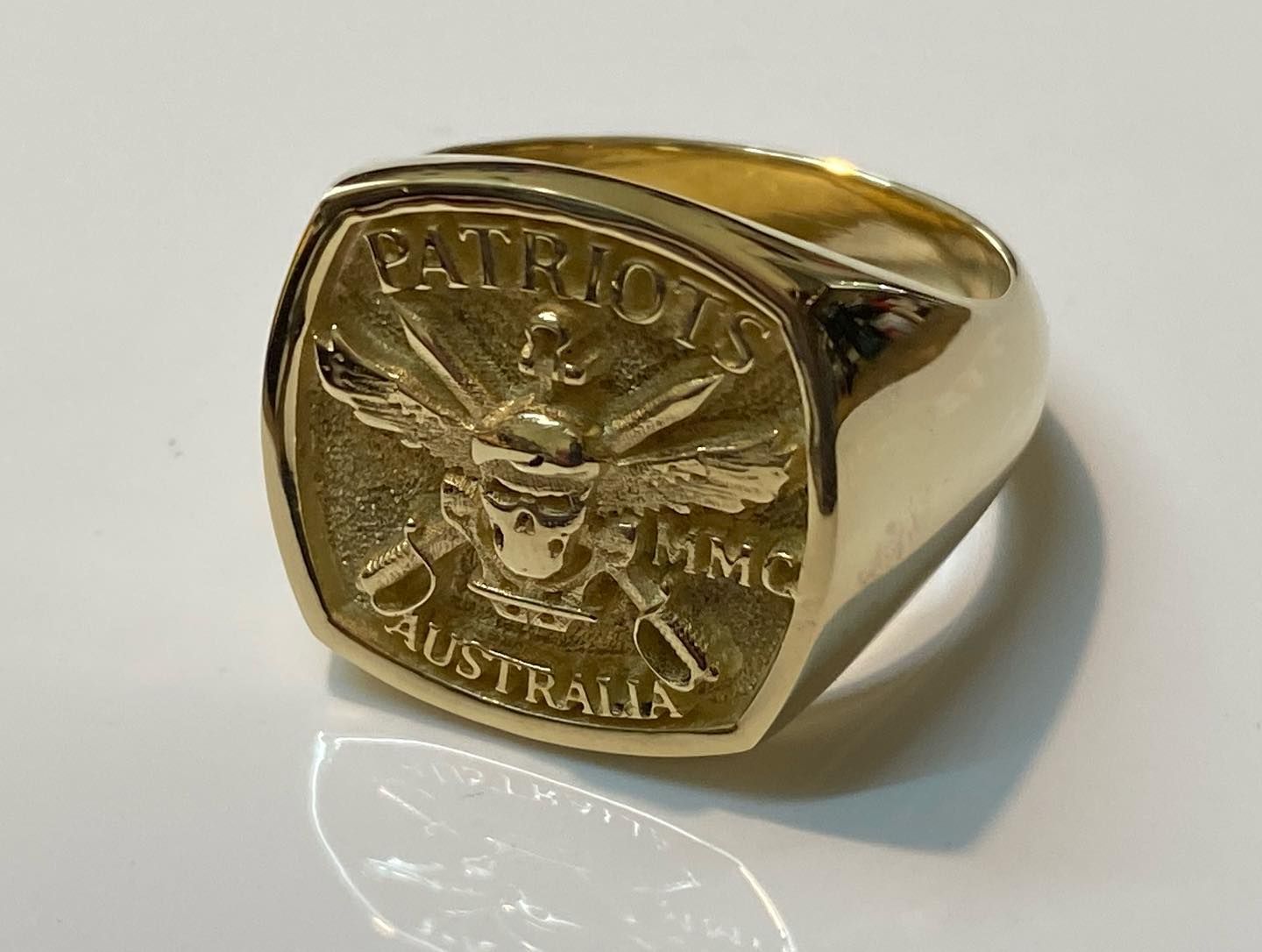 A gold signet ring featuring a skull with wings and crossed swords — Burchell's Jewellers In Bowral, NSW
