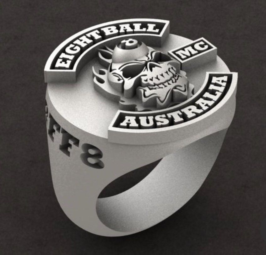 A silver ring featuring an engraved skull, a flaming eight ball — Burchell's Jewellers In Bowral, NSW