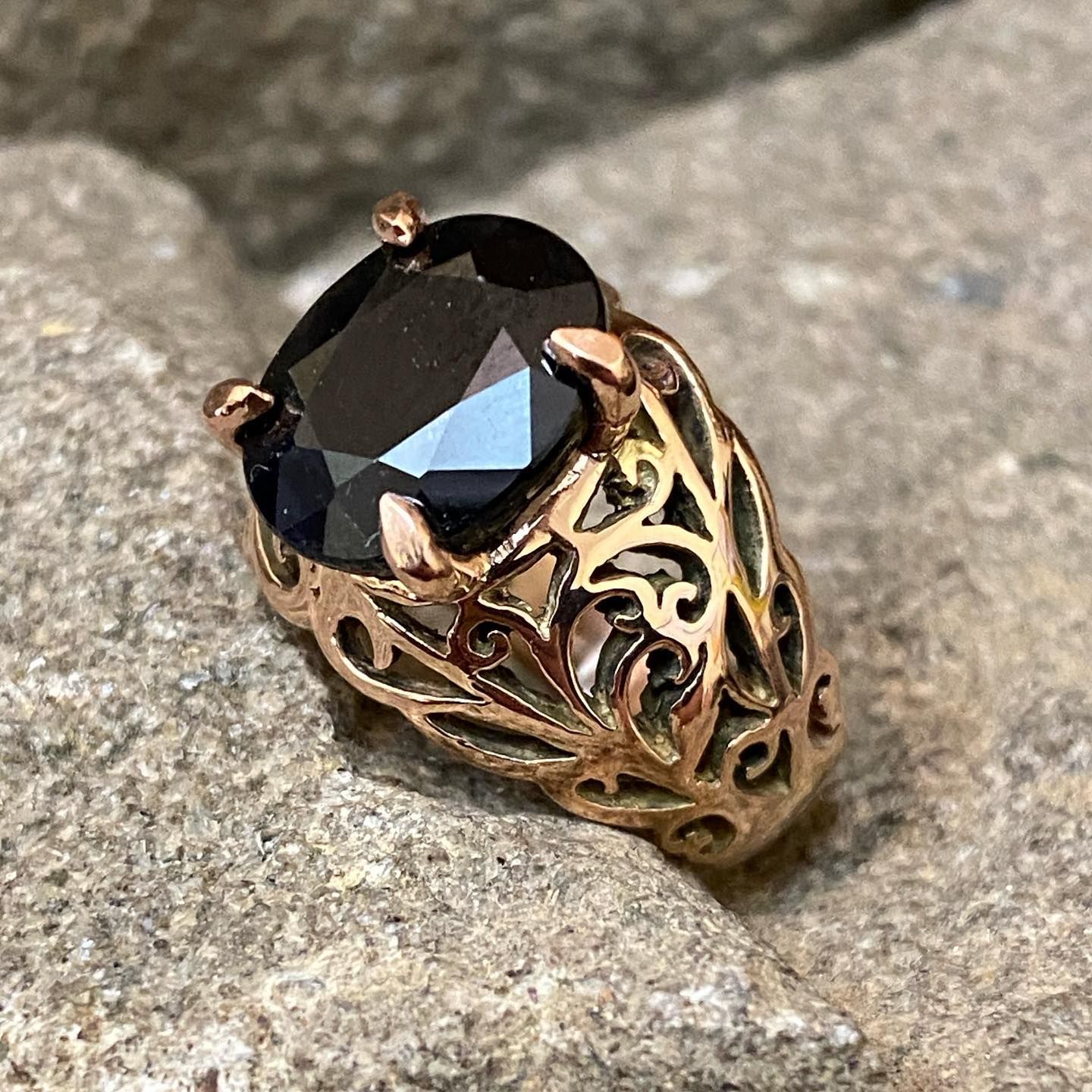 Gold-tone filigree ring with a large, oval-cut black stone. — Burchell's Jewellers In Bowral, NSW