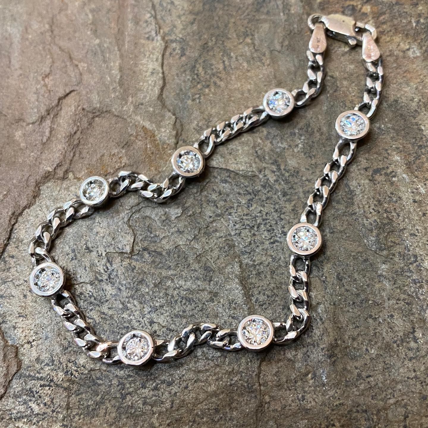 Silver bracelet with a curb chain and bezel-set round diamonds. — Burchell's Jewellers In Bowral, NSW