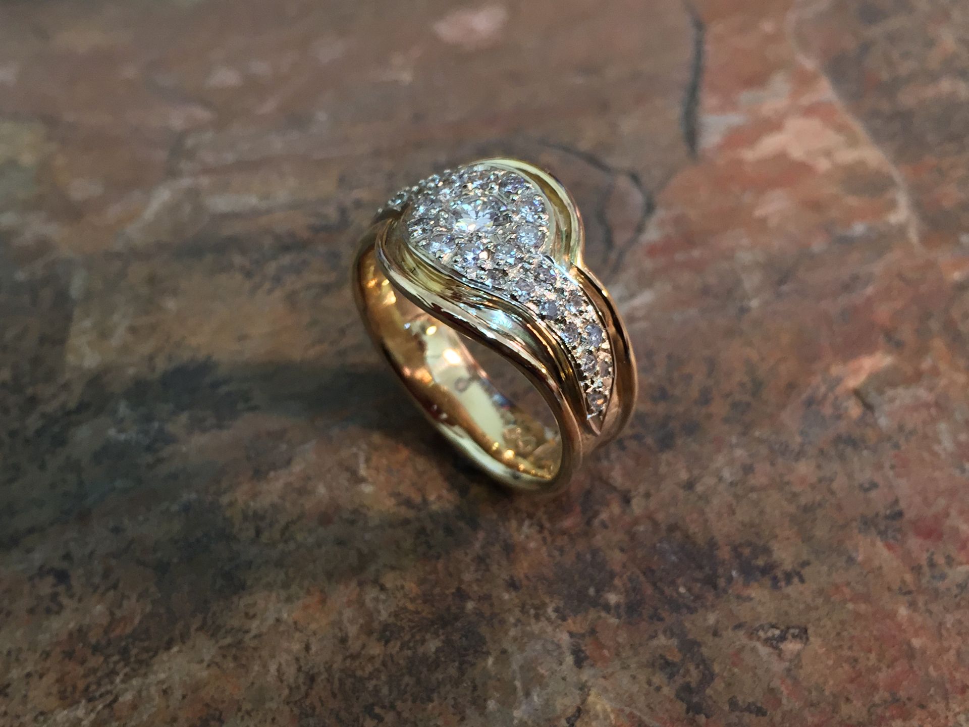 Gold Ring With Numerous Small Diamonds on a Textured Brown Surface — Burchell's Jewellers In Bowral, NSW