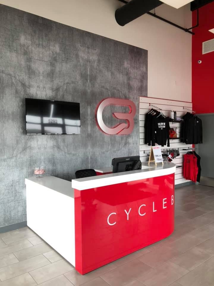 A reception desk with a red front labeled 