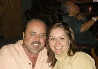 Smiling couple posing together indoors in warm lighting