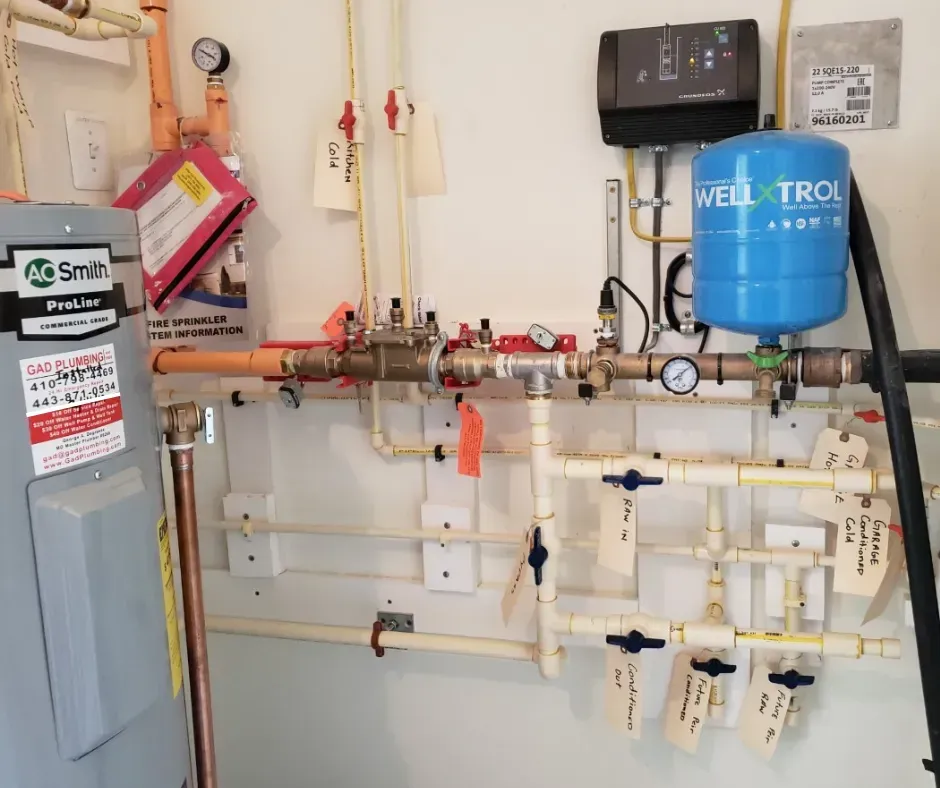 Wall-mounted boiler and plumbing system with pipes, valves, and a blue expansion tank in a utility room