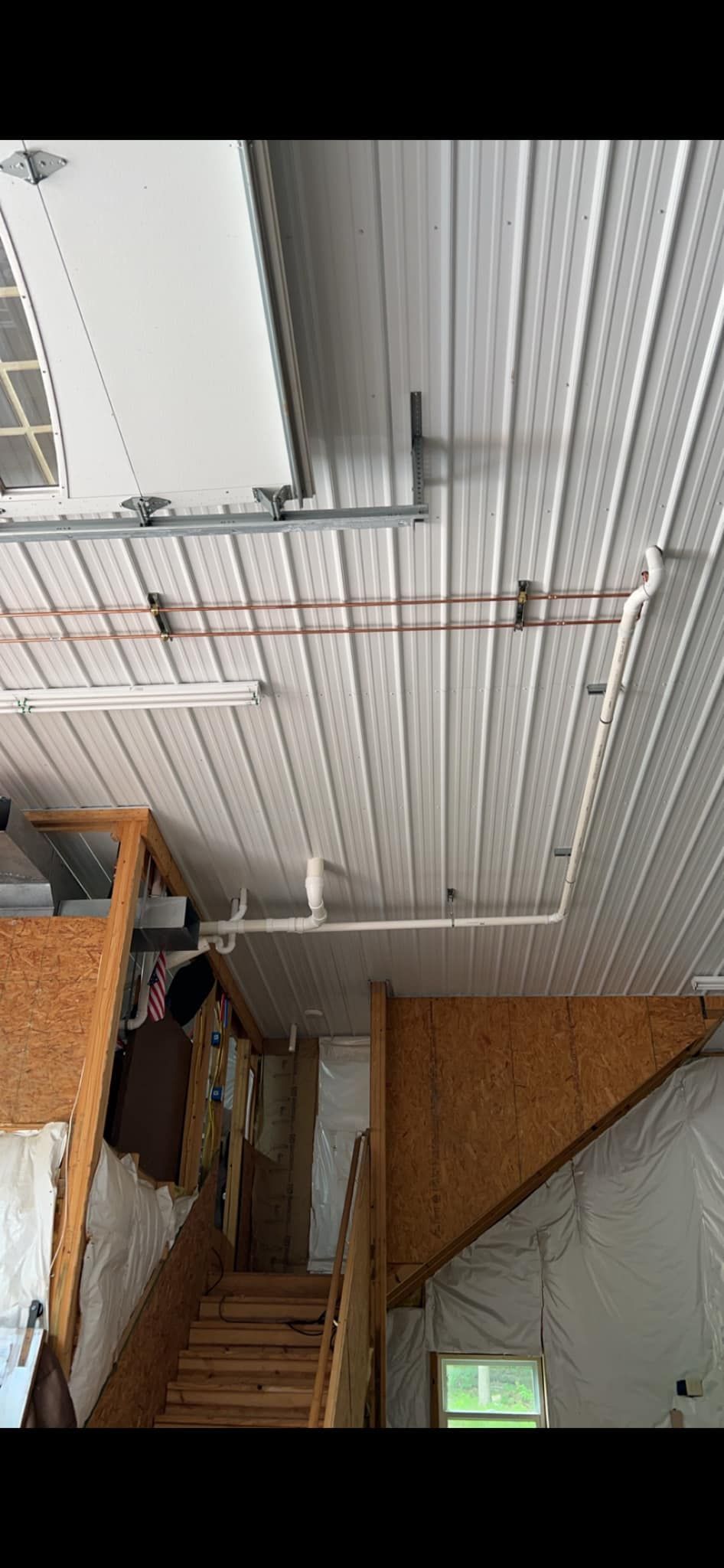 A room with a staircase and a white ceiling.