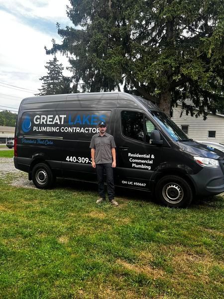 A man is standing in front of a van.